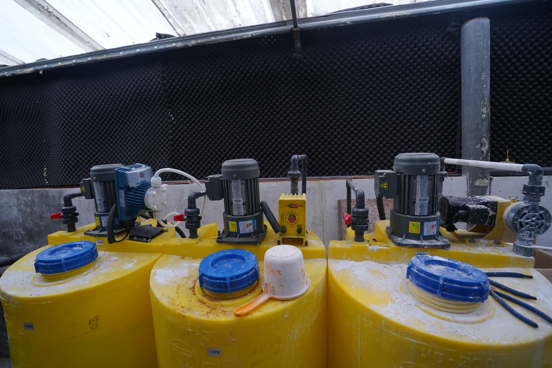Chemical dosing tanks and metering pumps at an industrial nickel wastewater treatment installation