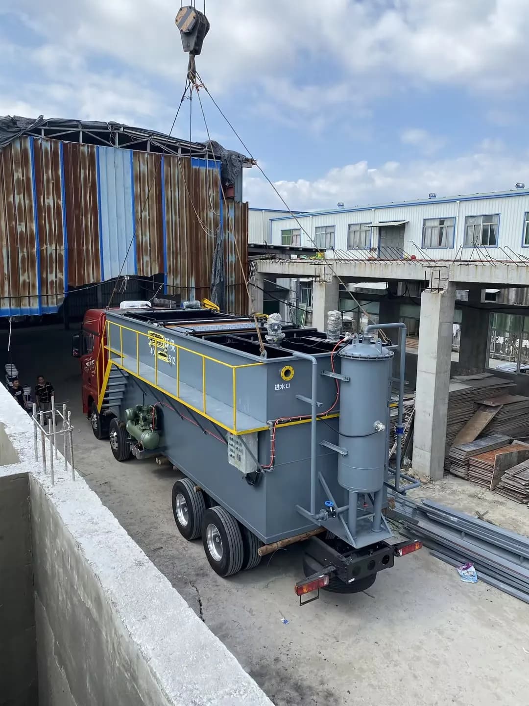 Packaged wastewater treatment unit being positioned at a slaughterhouse project site