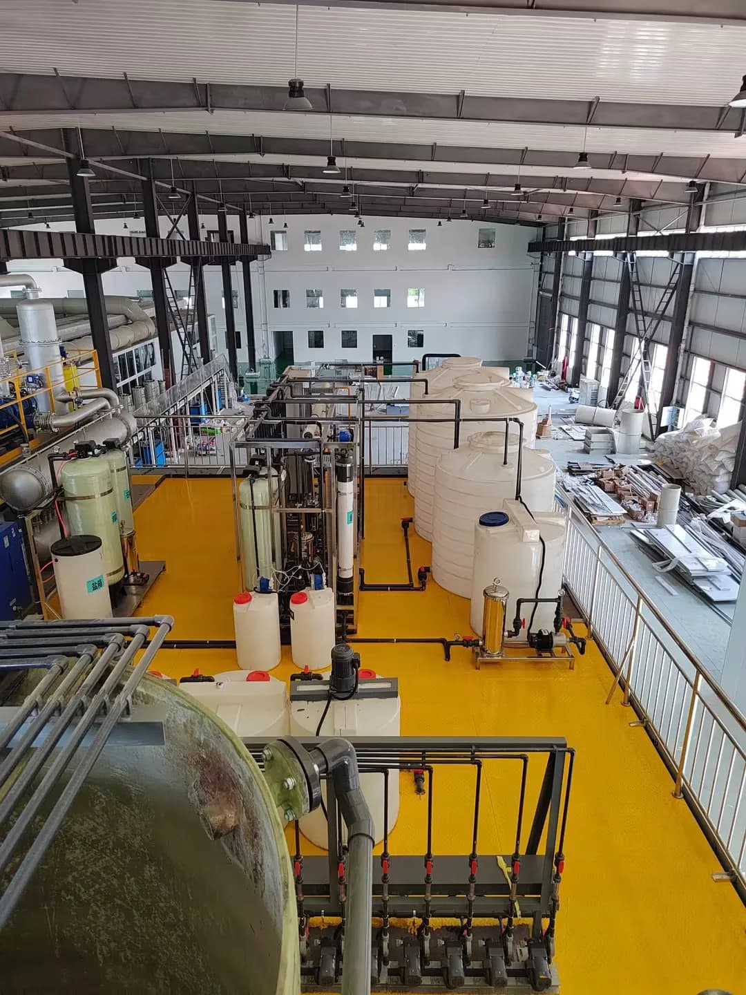 Water treatment vessels, tanks and connecting pipework viewed from an elevated walkway